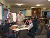 A group of adults sitting around a round table having a meeting