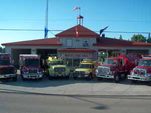 Six fire rescue vehicles parked at a fire station facility